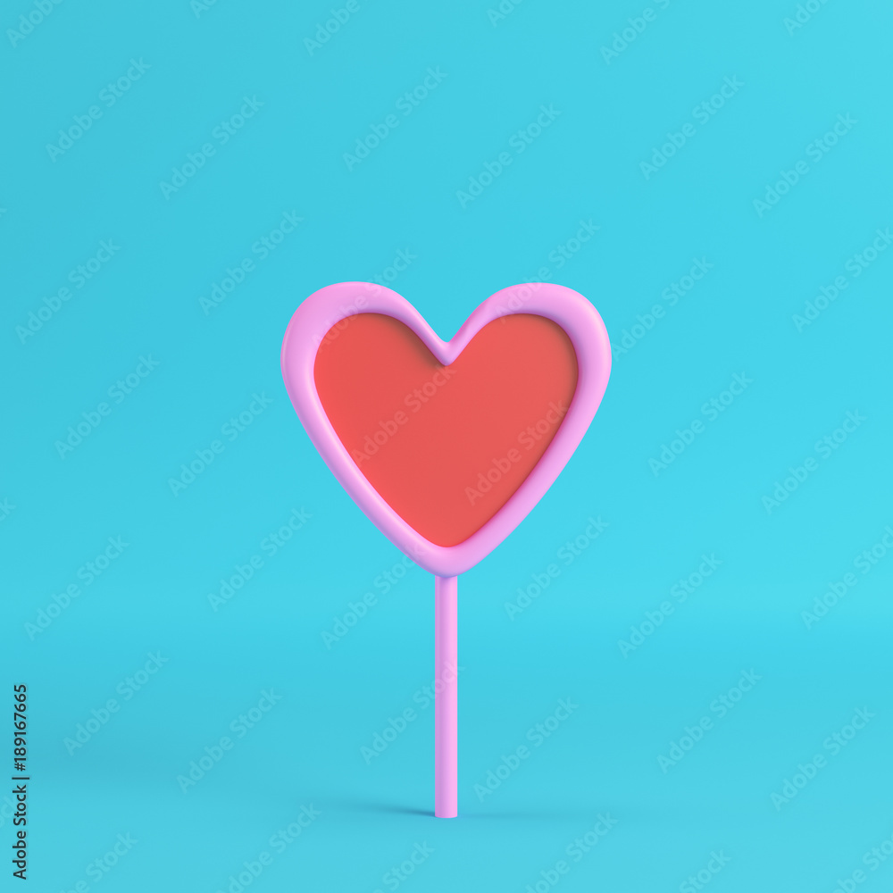 Pink with red heart on a stick on bright blue background Pink with red heart on a stick on bright blue background