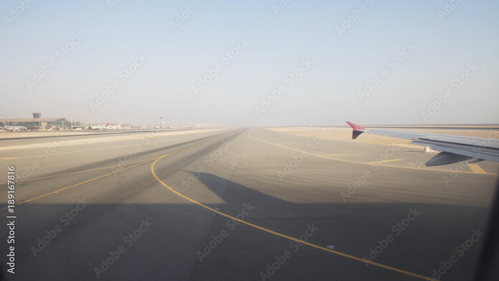 Takeoff of the aircraft from the airfield, View through an airplane window. Travel concept. Takeoff of the aircraft from the airfield, View through an airplane window. Travel concept.