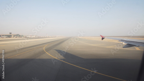 Takeoff of the aircraft from the airfield, View through an airplane window. Travel concept.