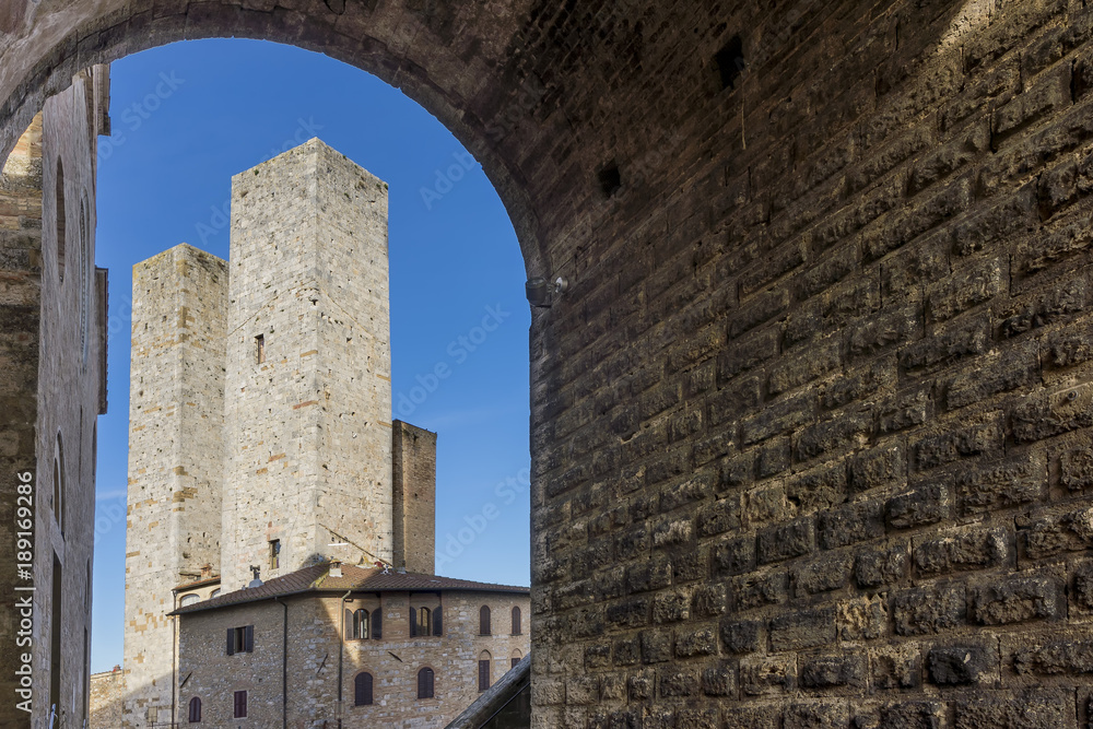 The towers of San Gimignano through an arch, Siena, Tuscany, Italy