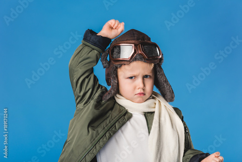 portrait of preteen boy in pilot costume isolated on blue © LIGHTFIELD STUDIOS