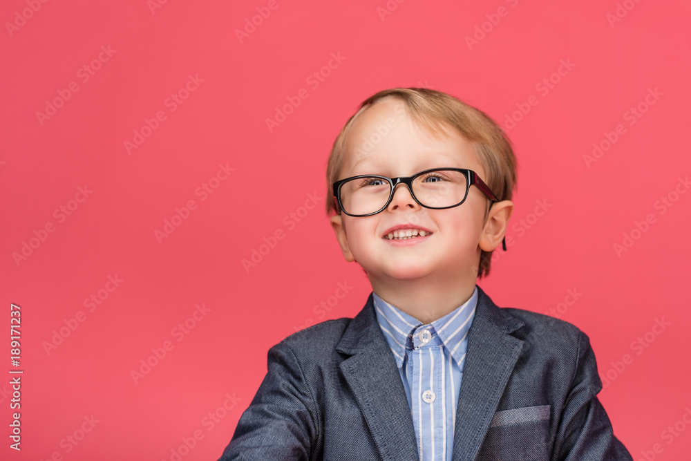 portrait of smiling little boy in eyeglasses isolated on pink portrait of smiling little boy in eyeglasses isolated on pink