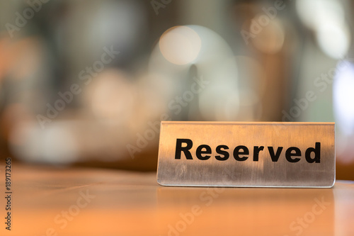 Reserved sign on a wooden table in cafe shop