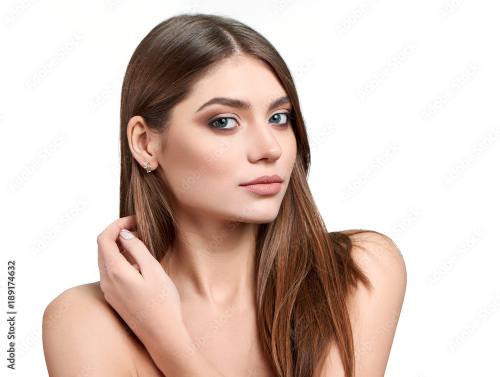 Fullface half profile portrait of a beautiful green-eyed brunette model with makeup on, such as nude lipstick and eyeshadows and touching her hair. Fullface half profile portrait of a beautiful green-eyed brunette model with makeup on, such as nude lipstick and eyeshadows and touching her hair.