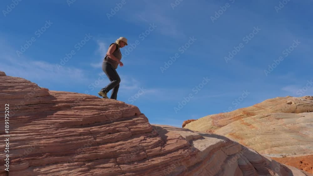 Tourist Woman Hiking Down The Crest Hill With Colorful Red Rocks Slow Motion 4K Tourist Woman Hiking Down The Crest Hill With Colorful Red Rocks Slow Motion 4K