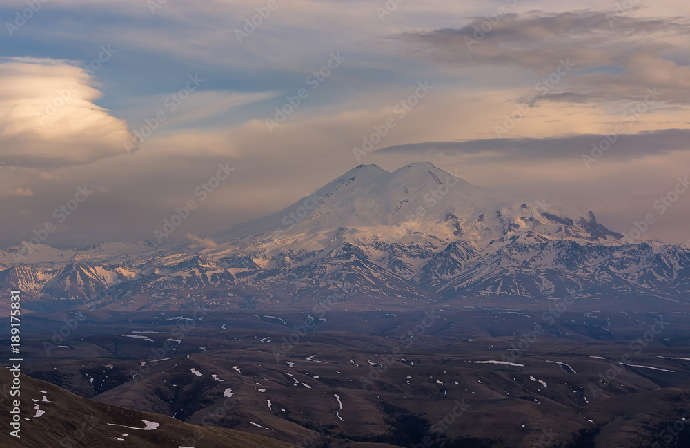 Snow tops of high Mount Elbrus at sunset, mountain landscape, sights and nature of the North Caucasus