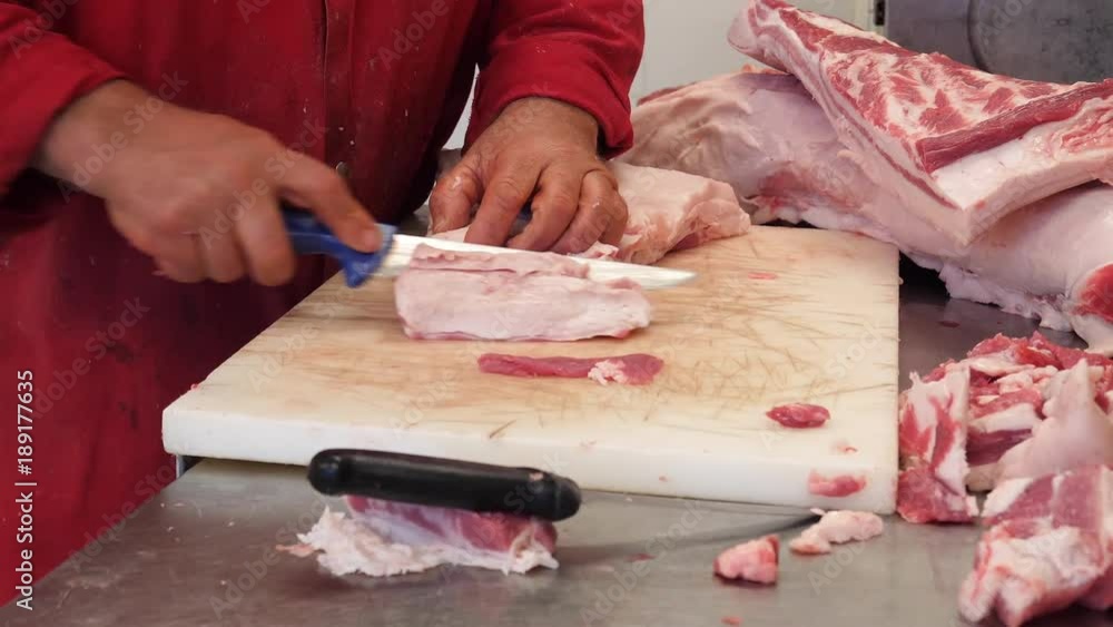 Butcher cuts pork meat in a slaughterhouse, slow motion, 4K Butcher cuts pork meat in a slaughterhouse, slow motion, 4K