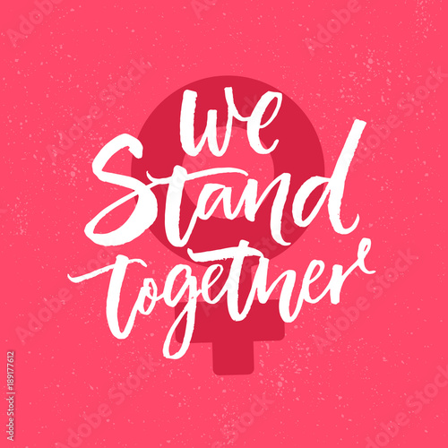 We stand together. Inspirational feminism slogan, brush calligraphy inscription on pink background with female gender symbol.