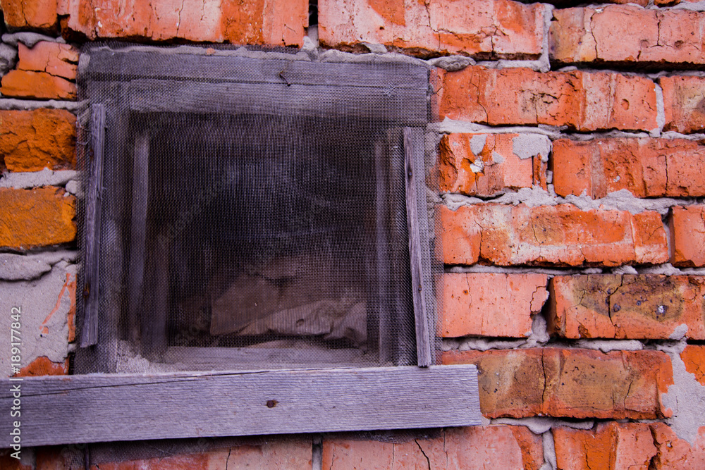 mesh window in a brick wall