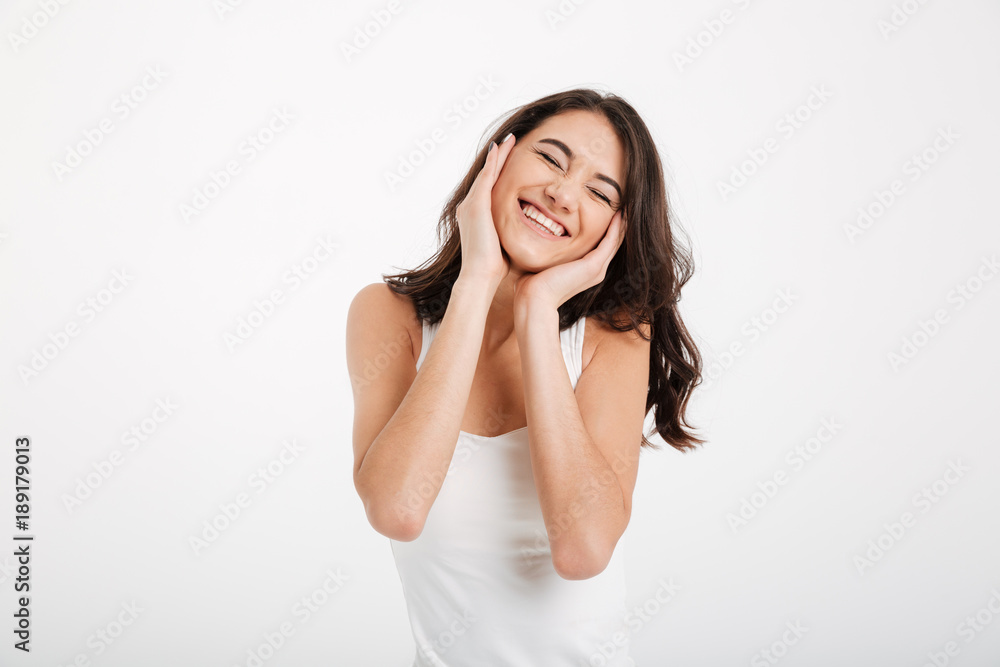 Portrait of a lovely girl dressed in tank-top laughing Portrait of a lovely girl dressed in tank-top laughing