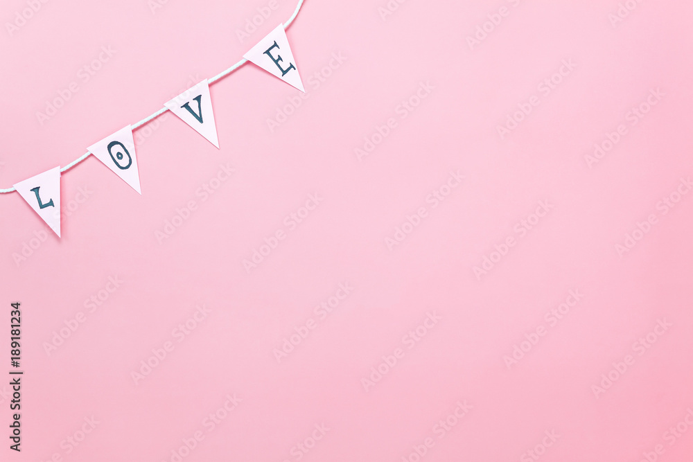 Table top view aerial image of valentine 's day background concept.Love text hang on rope clotheslines.Flat lay on modern rustic pink paper.pastel tone.Items create by handmade sign for the season.