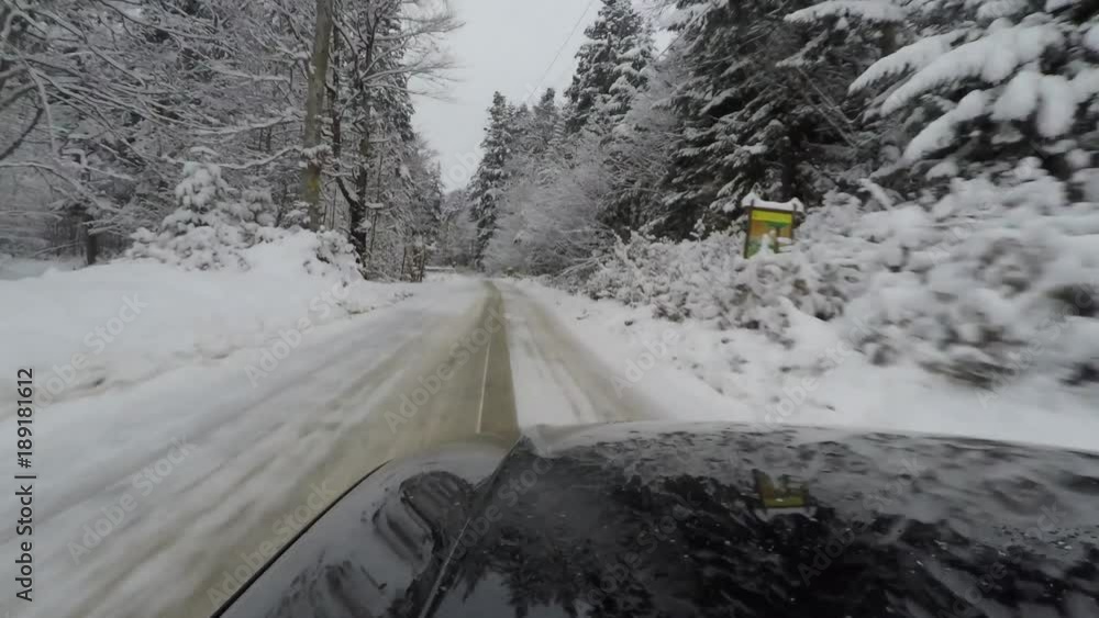 Car driving along snowy road; car mounted camera Car driving along snowy road; car mounted camera