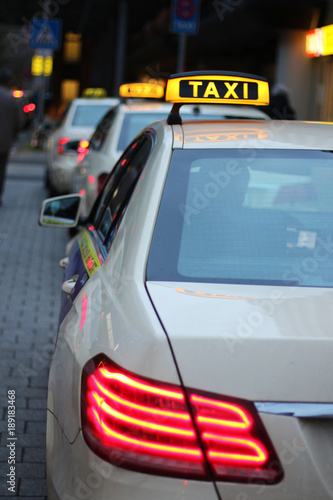taxis waiting in a row, at dusk
