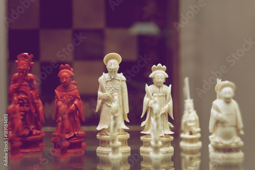 Cut from the bone chess pieces of the king and queen of the opposing sides. China.