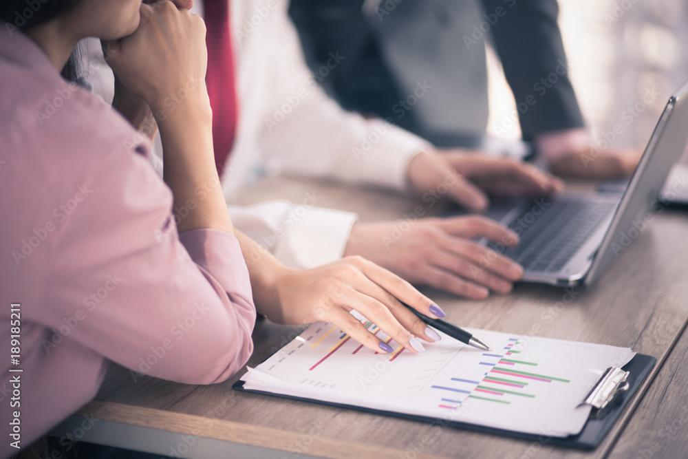 Thre people are working at desk with laptop and documents. Business concept. Thre people are working at desk with laptop and documents. Business concept.