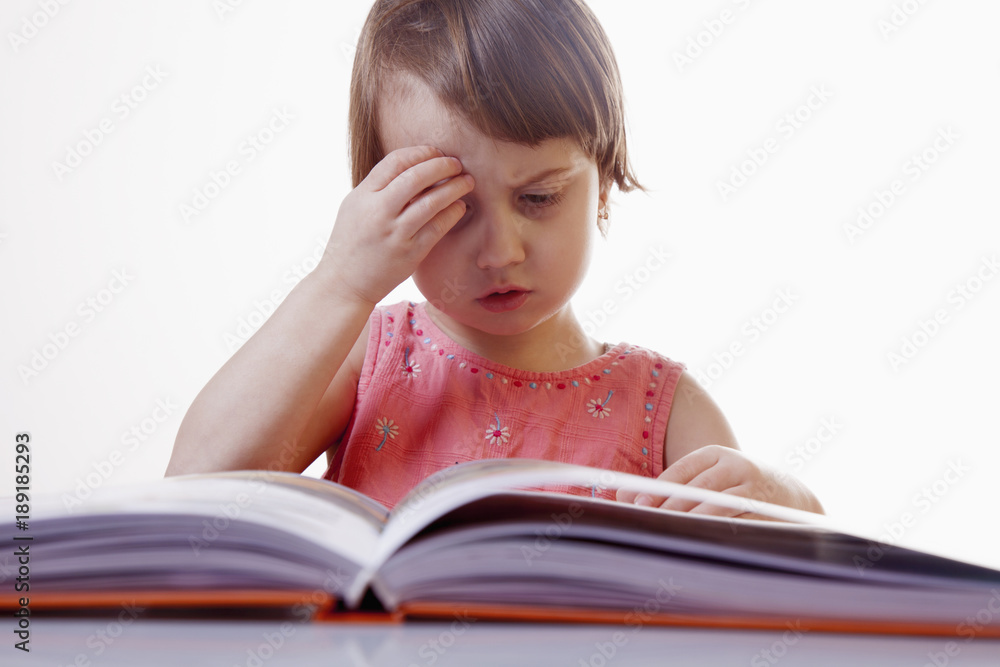 Little cute child girl watching a book (Science, education, knowledge, self-improvement, success) Little cute child girl watching a book (Science, education, knowledge, self-improvement, success)