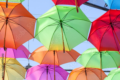 A lot of multi-colored umbrellas hang. Scenery  holiday