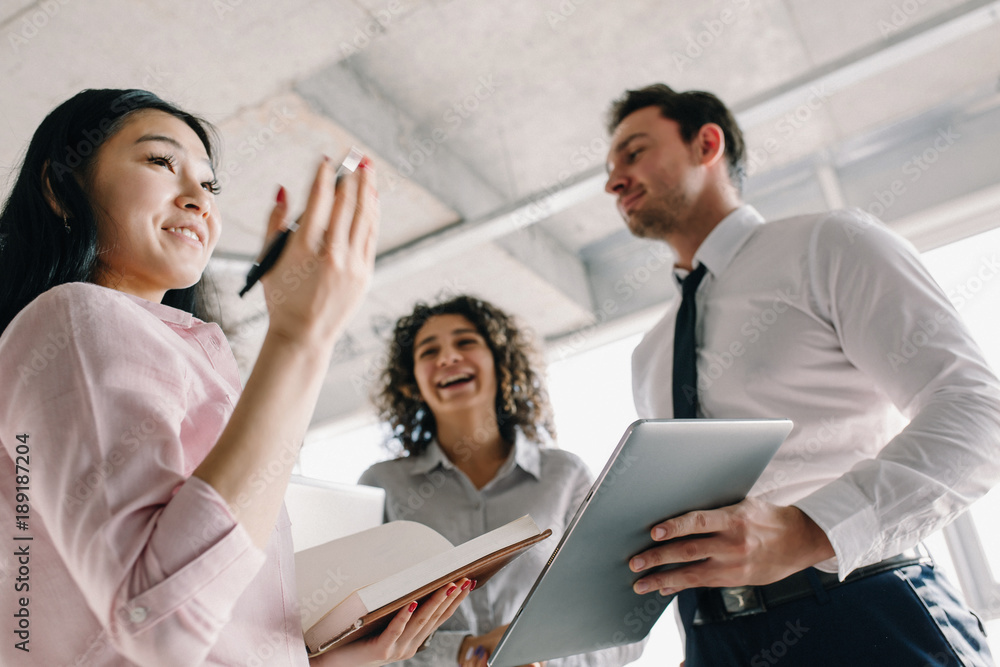 Smiling managers in office. Agreed some project points.