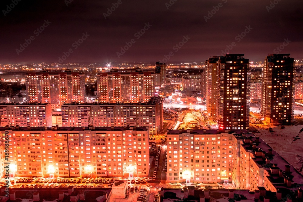 a night city view with lots of lights and buildings