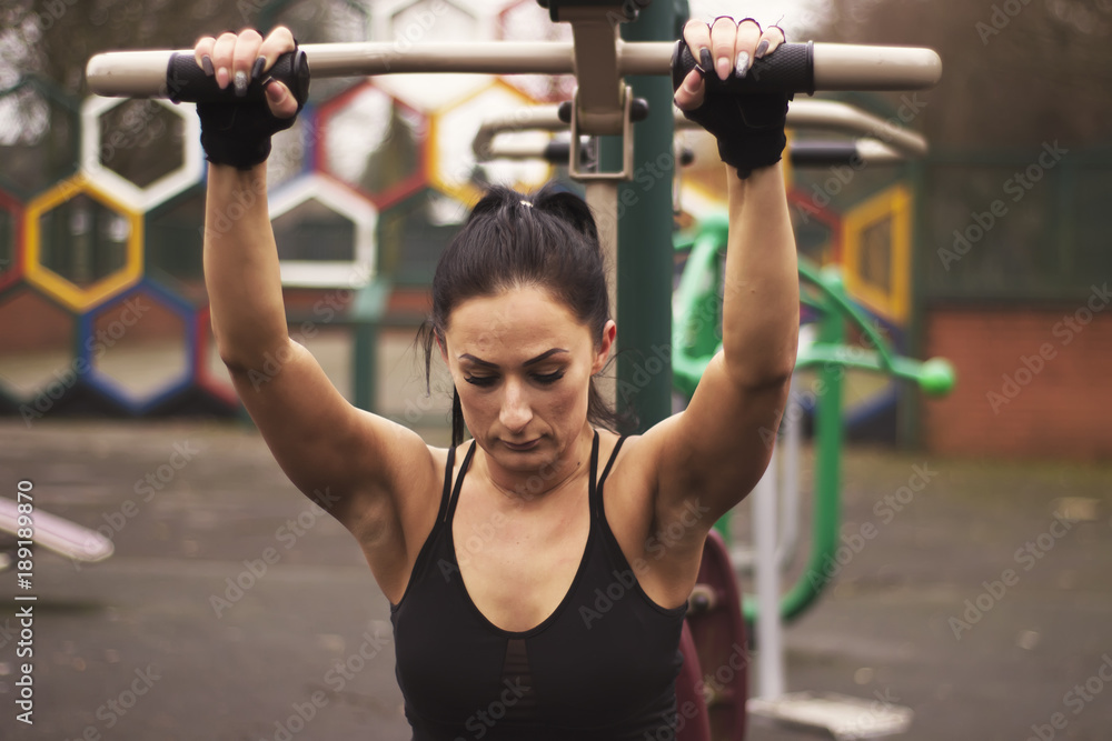Strong and physically fit young woman, fitness female exercising outdoors. Strong and physically fit young woman, fitness female exercising outdoors.