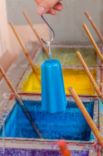 coloring candles by dipping in blue paint