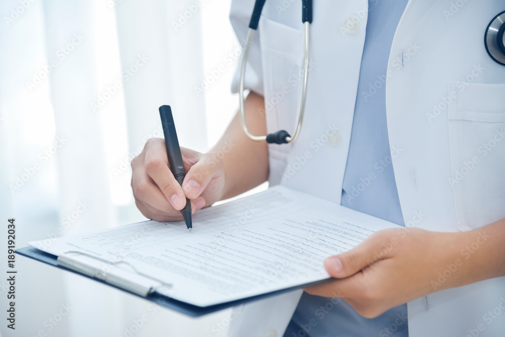 Doctor taking note on checklist paper. Doctor taking note on checklist paper.