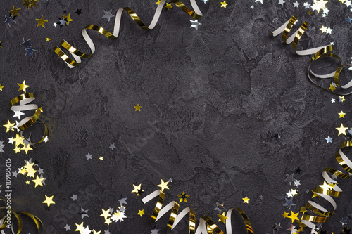 Bright festive carnival background with hats, streamers, confetti and balloons