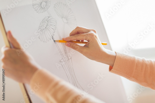 Фотография artist with pencil drawing picture at art studio