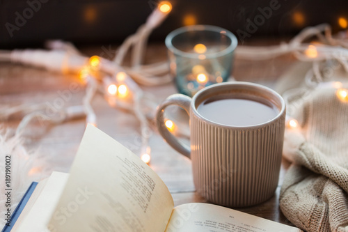 book and cup of coffee or hot chocolate on table