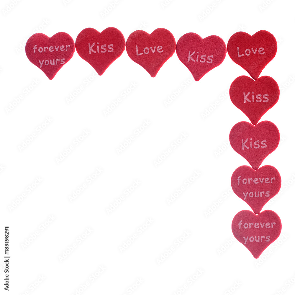 Red hearts confetti on white background with words love kiss