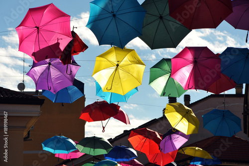 Umbrellas hanging in the city,
Umbrellas that fly