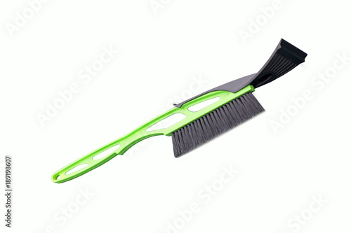 Brush for snow cleaning. Green brush on white background. Winter. Snow
