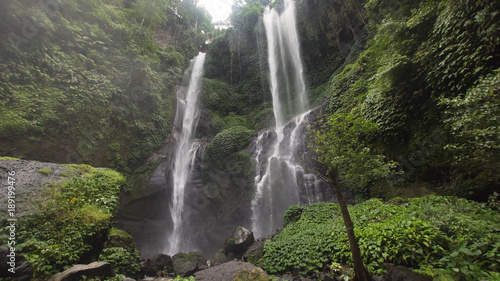 Fototapeta Naklejka Na Ścianę i Meble -  Waterfall in green rainforest. Triple waterfall Sekumpul in the mountain jungle. Bali,Indonesia. Travel concept.