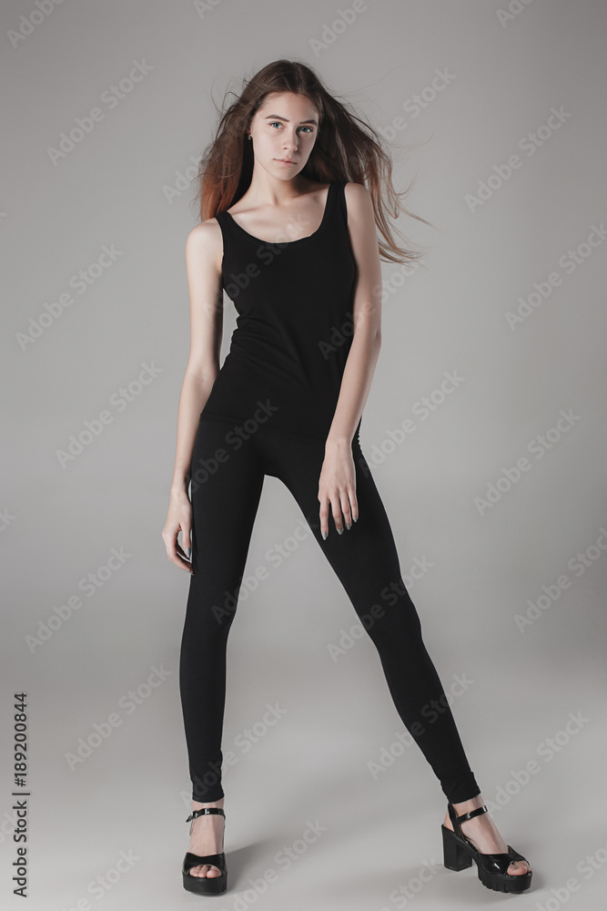 Young beautiful happy woman on gray background Young beautiful happy woman on gray background