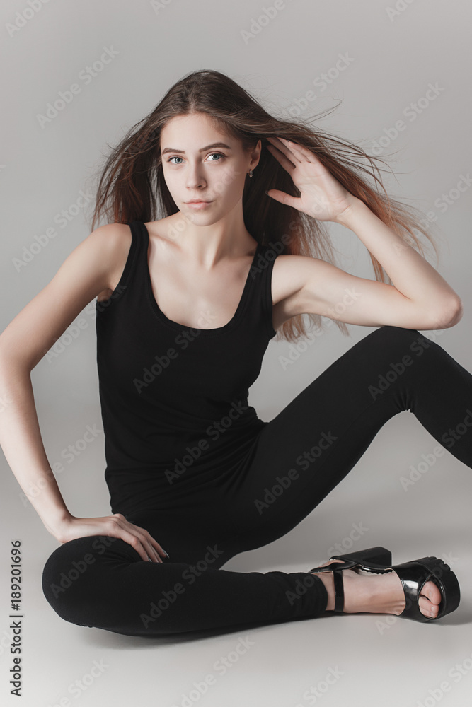 Young beautiful happy woman on gray background Young beautiful happy woman on gray background