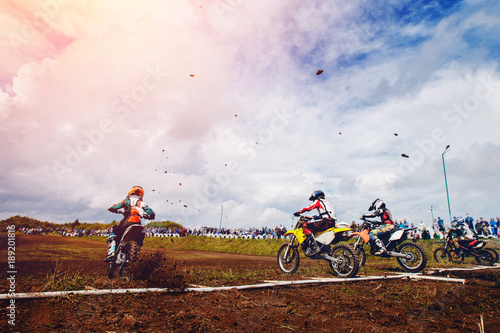 dirtbike Racers are at start of motorcycles.