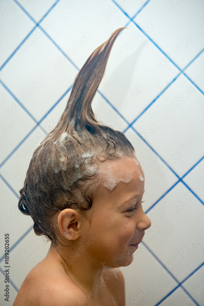funny little boy is washing his hair Stock Photo | Adobe Stock