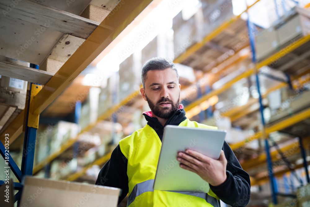 Male warehouse worker with tablet. Male warehouse worker with tablet.