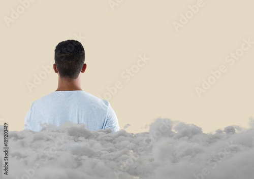 Teenager looking forward with clouds behind him