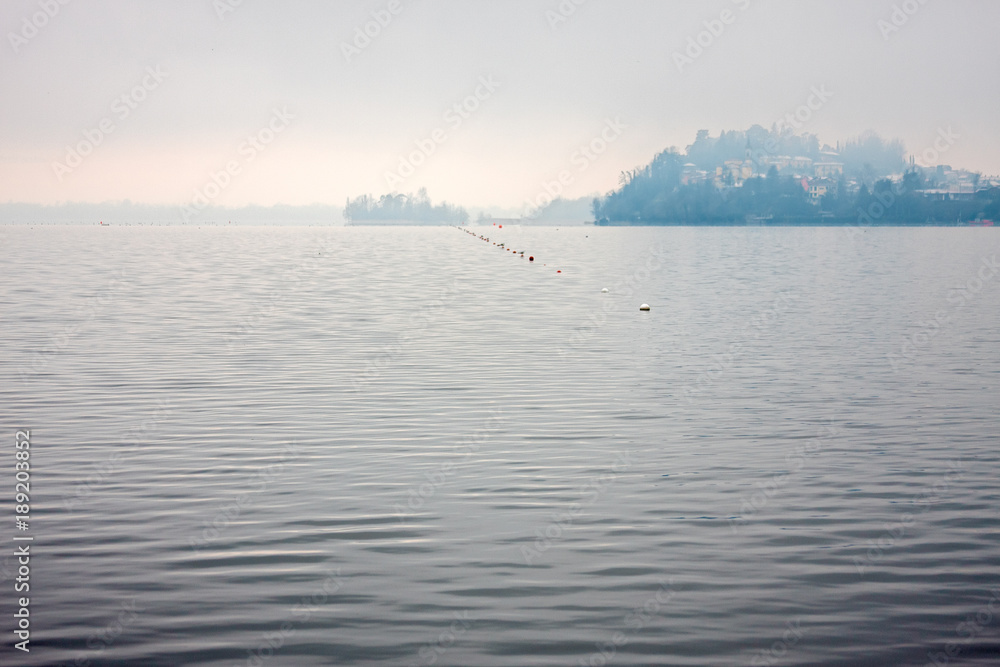 A rowing lane delimits a portion of the lake on a gray winter day A rowing lane delimits a portion of the lake on a gray winter day