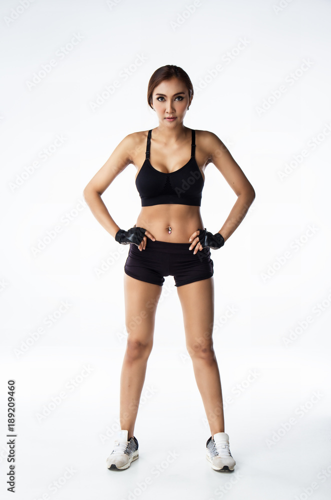 The lady in exercise suit is posing on background.she is standing on ground floor and put her hand beside hip,prepare for exercise The lady in exercise suit is posing on background.she is standing on ground floor and put her hand beside hip,prepare for exercise
