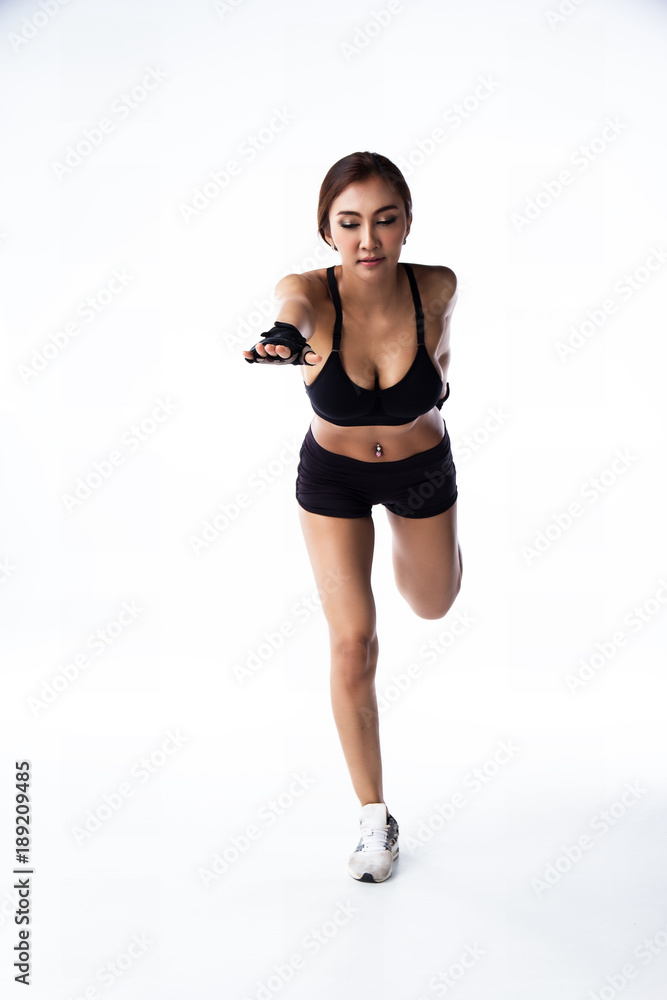 The lady in exercise suit is standing with right leg and raise left leg at the back of her body,raise right hand forward,bend her body down,warm up pattern before exercise The lady in exercise suit is standing with right leg and raise left leg at the back of her body,raise right hand forward,bend her body down,warm up pattern before exercise
