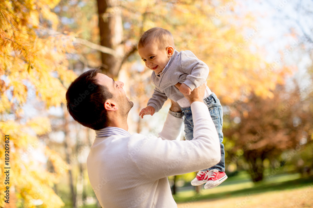 Young father and baby boy in autumn park Young father and baby boy in autumn park