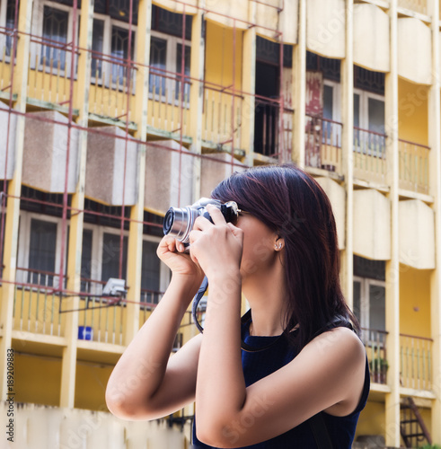 The lady with sun glasses is taking photo by camera ,outside activity for holiday. photo