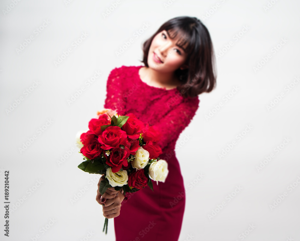In selective of rose bouquet in blurred lady hand with red dress,blurry light around. In selective of rose bouquet in blurred lady hand with red dress,blurry light around.