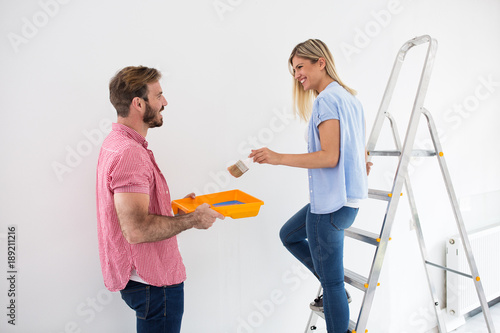 Young couple painting walls