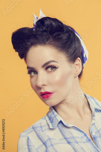 beautiful girl in pin-up style on a yellow background