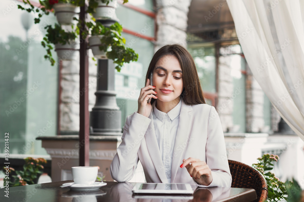 Young businesswoman talking on phone outdoors Young businesswoman talking on phone outdoors
