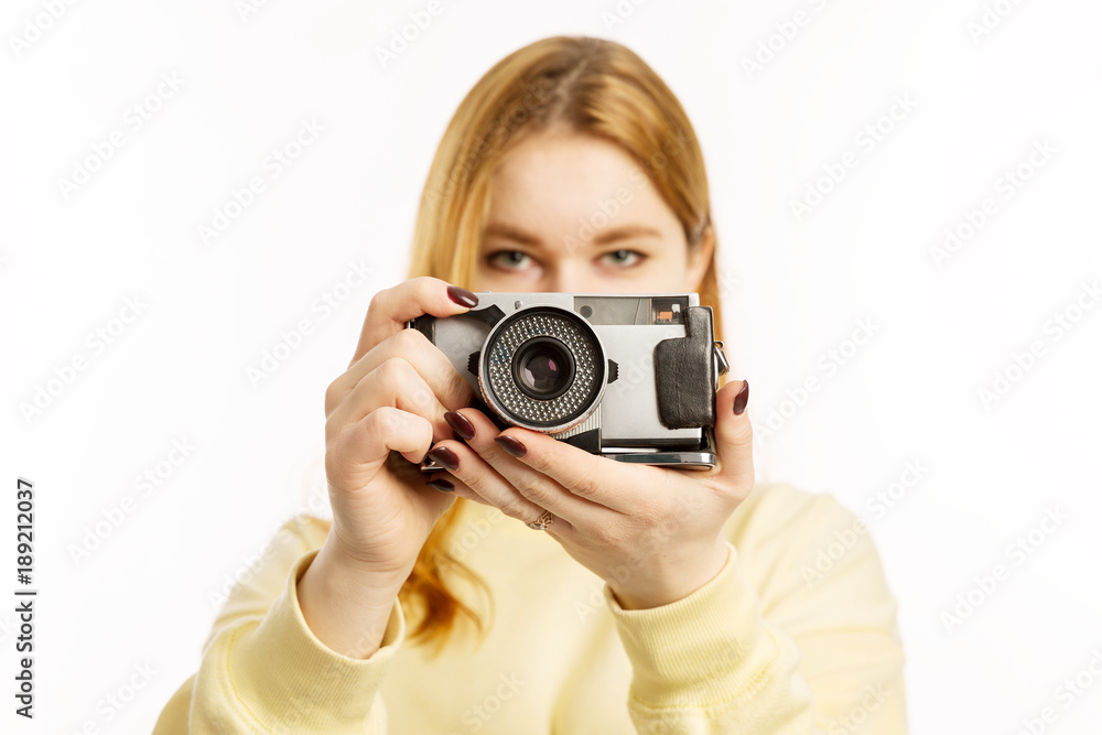 Young woman with an old camera smiling Young woman with an old camera smiling