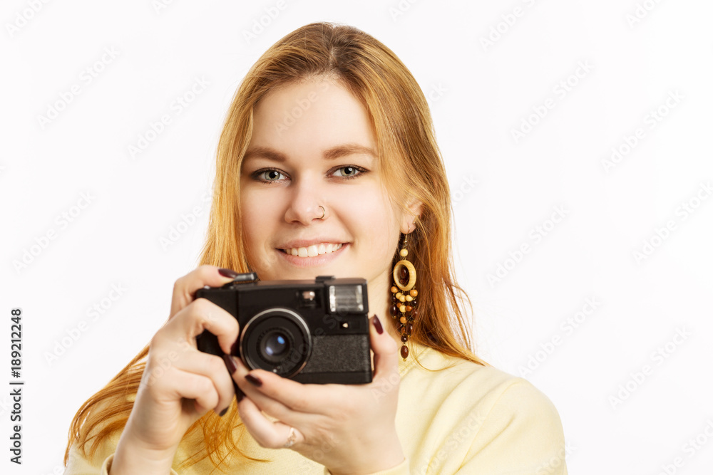 Young woman with an old camera smiling Young woman with an old camera smiling